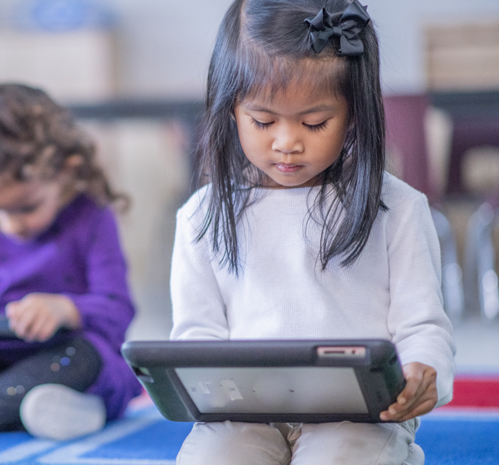 School age student interacting on a tablet device